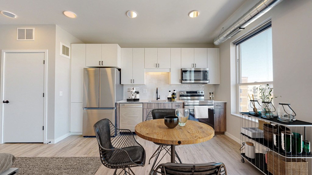a kitchen and dining area in a 555 waverly unit