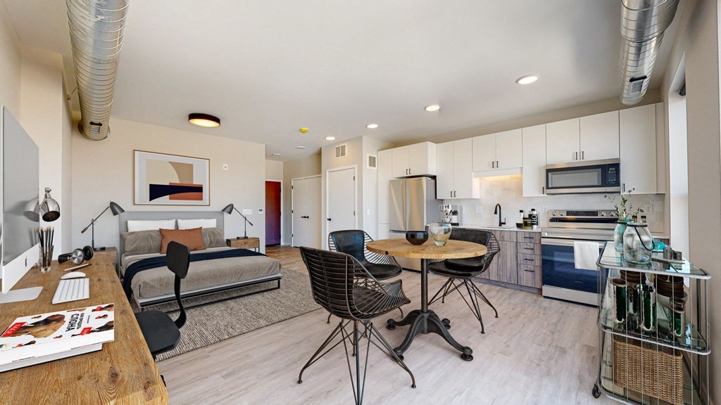 a bedroom with a bed and a table and chairs in a room