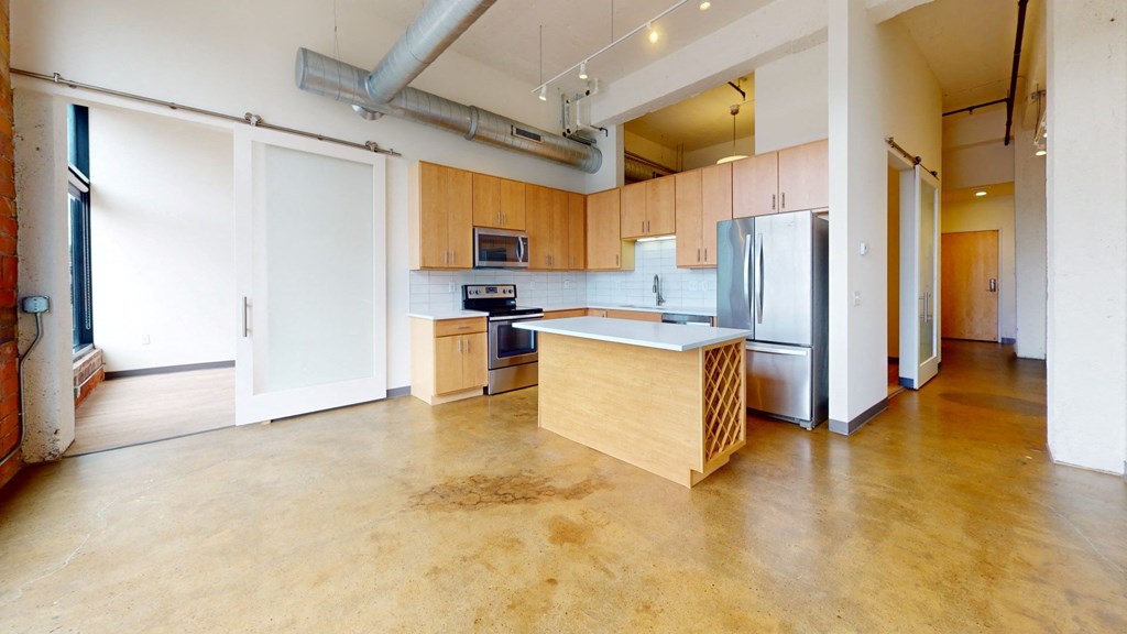 a large kitchen with wood cabinets and stainless steel appliances