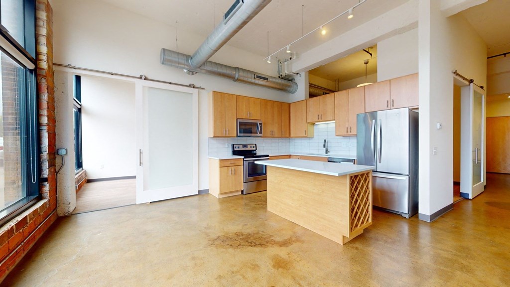 a kitchen with wood cabinets and stainless steel appliances