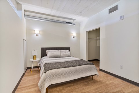 a bedroom with a bed and a door to a closet