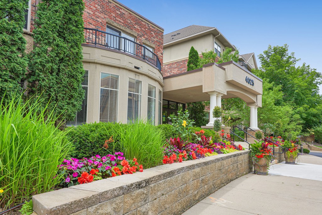a house with flowers and plants in front of it
