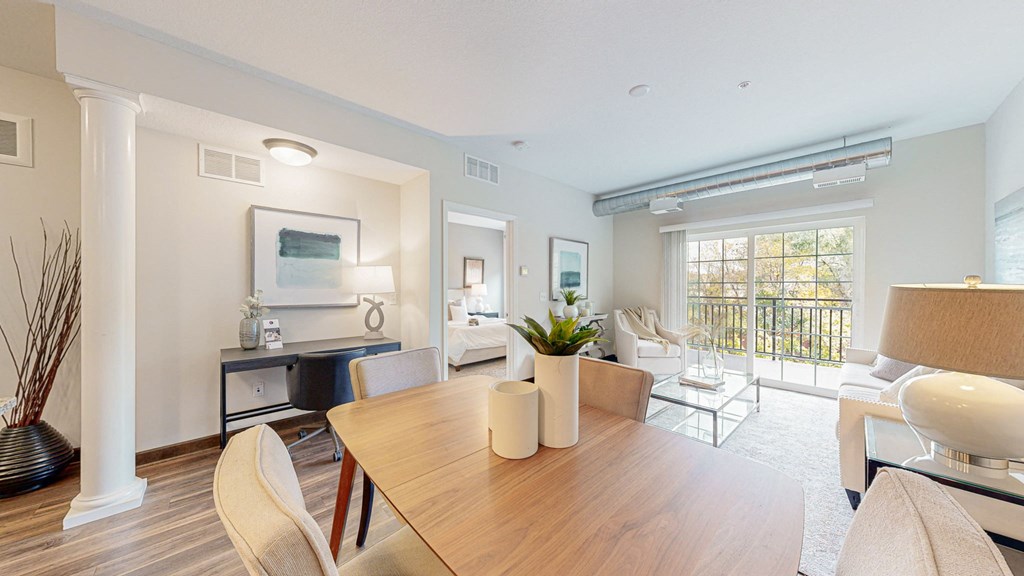 a living room and dining room with a table and chairs