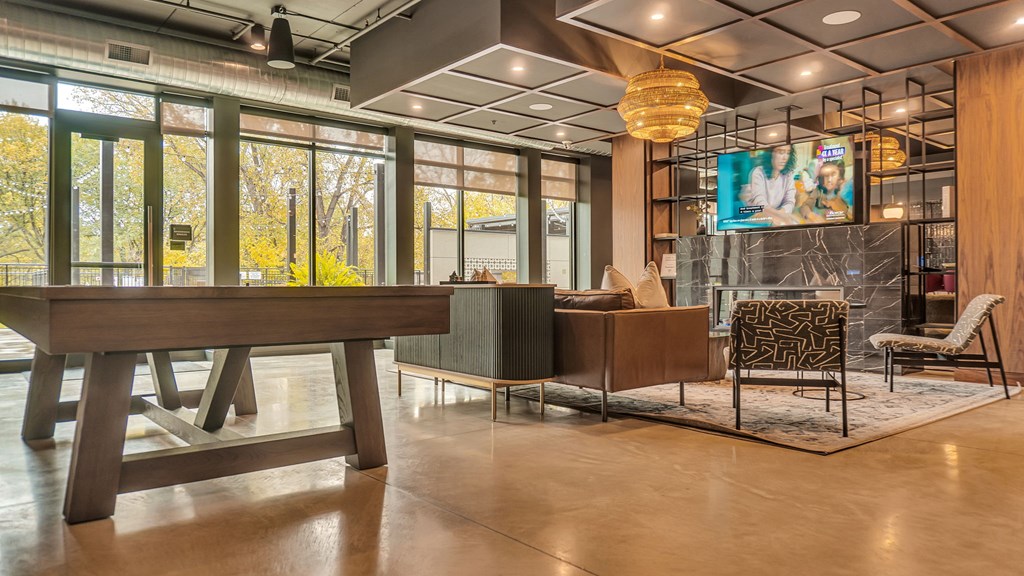 A room with a wooden table and a chair with a patterned cushion.