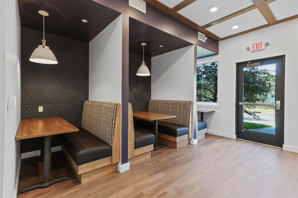 a seating area with two tables and two chairs