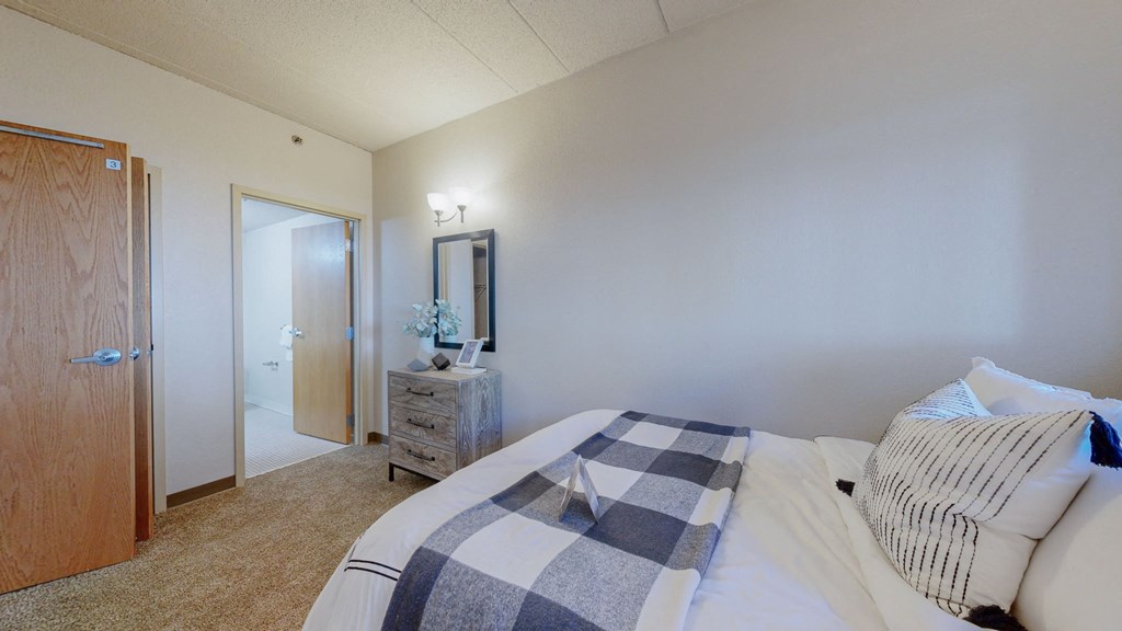a bedroom with a bed and a door to a bathroom at Bierman Place, Minneapolis, Minnesota