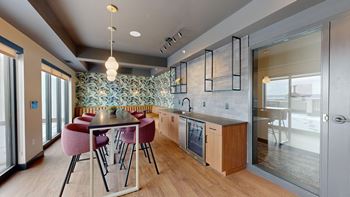 A modern kitchen with a dining table and chairs.