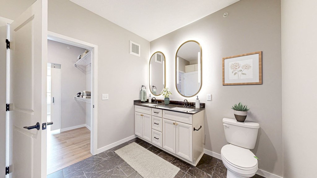 a bathroom with a toilet and a sink at Ardor on the Bluffs South Loop Residences Apartments, Bloomington, Minnesota