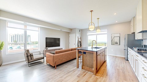 an open living room with a kitchen and a tv