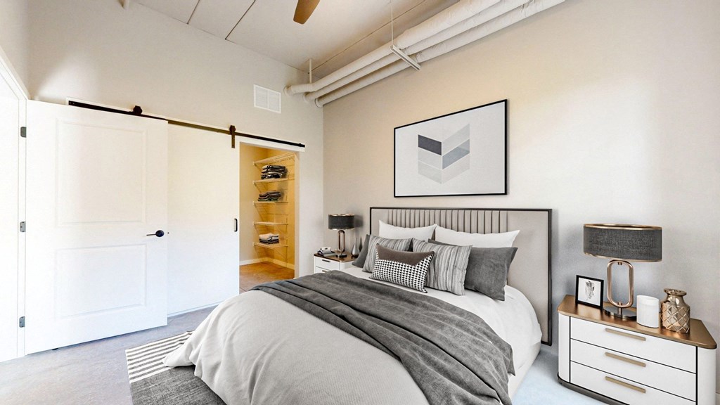 a bedroom with a bed and a closet at Ardor on the Bluffs South Loop Residences Apartments, Bloomington, 55425