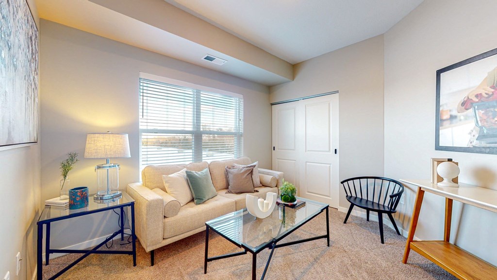 a living room with a couch chair and coffee table
