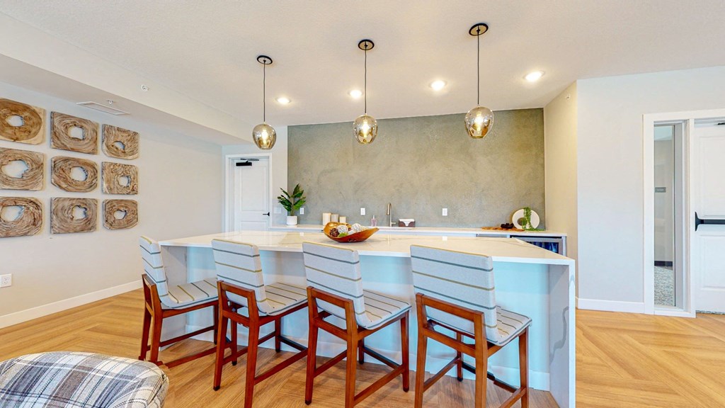 a kitchen with a large center island with a breakfast bar
