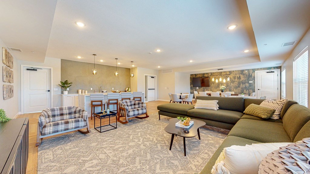 a living room with couches and chairs