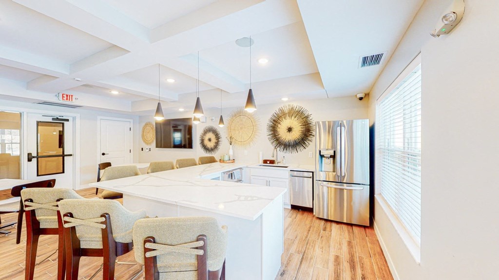 a large white kitchen with a large island