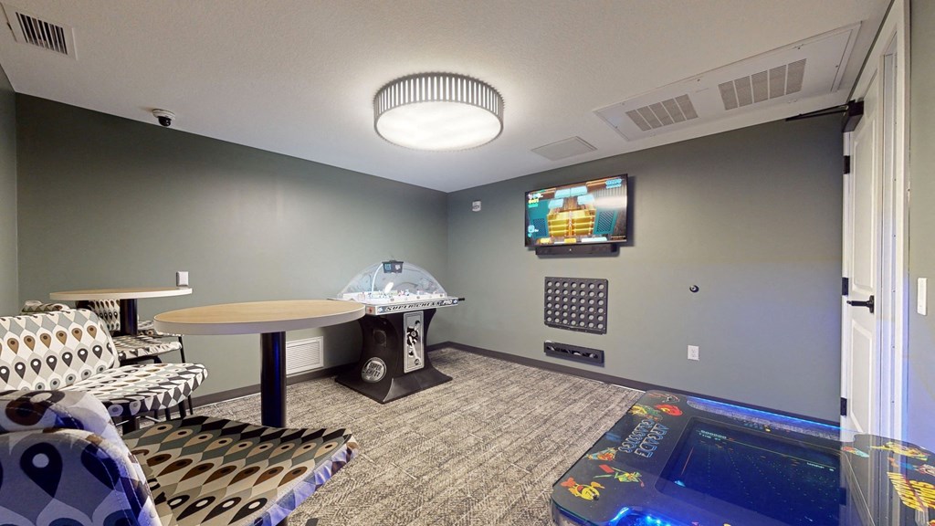 a room with a pool table and a tv