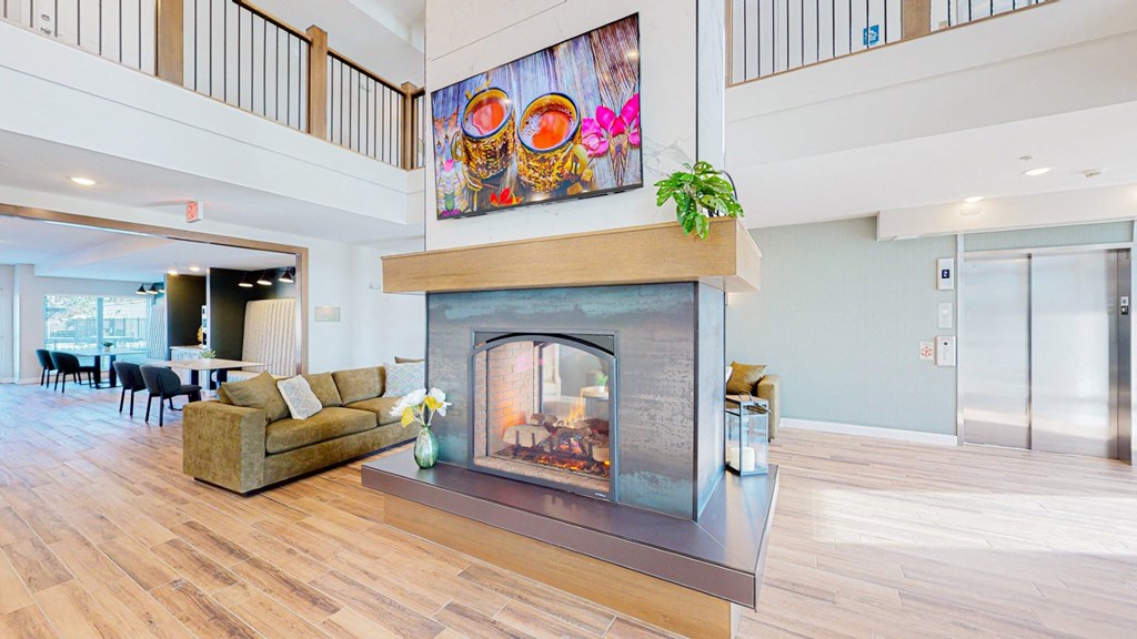 a living room with a fireplace and a painting on the wall