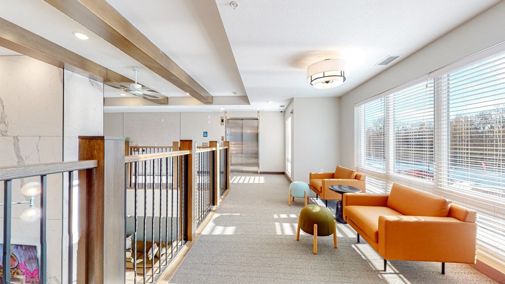 a long corridor with couches and tables