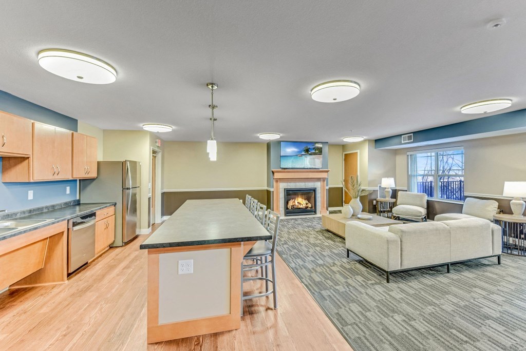 a large living room with a kitchen and a fireplace