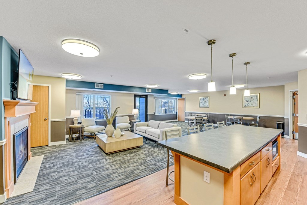 a large living room with a kitchen and a fireplace