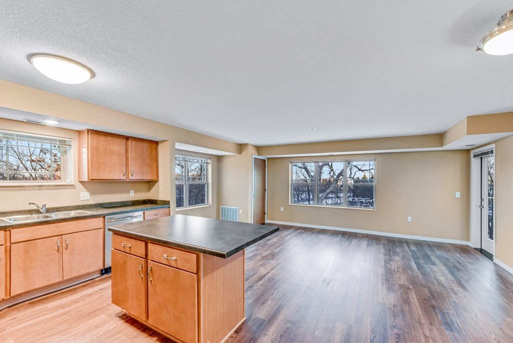 an empty kitchen with wooden cabinets and a counter top