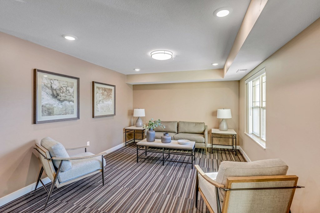 a living room with couches and chairs and a table