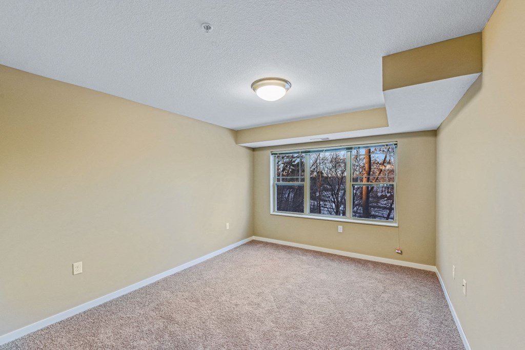 an empty living room with a large window