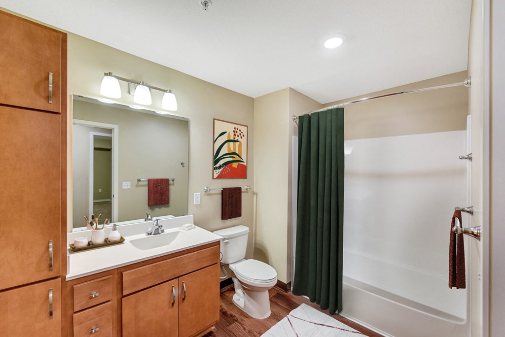 a bathroom with a toilet and a sink and a shower