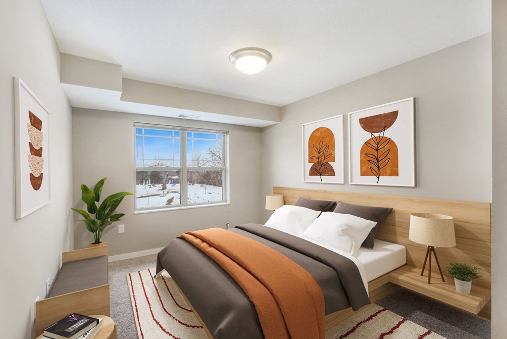 a bedroom with a bed and paintings on the wall