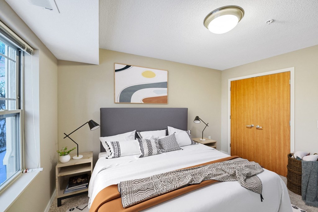 a bedroom with a large bed and a window