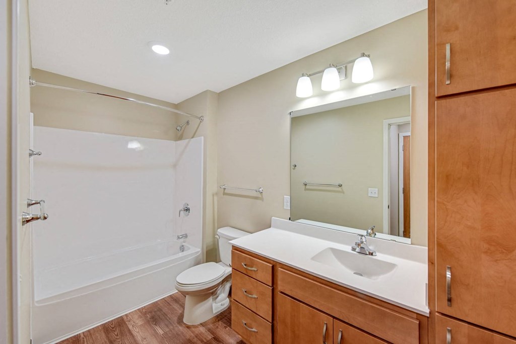 a bathroom with a sink toilet and a mirror