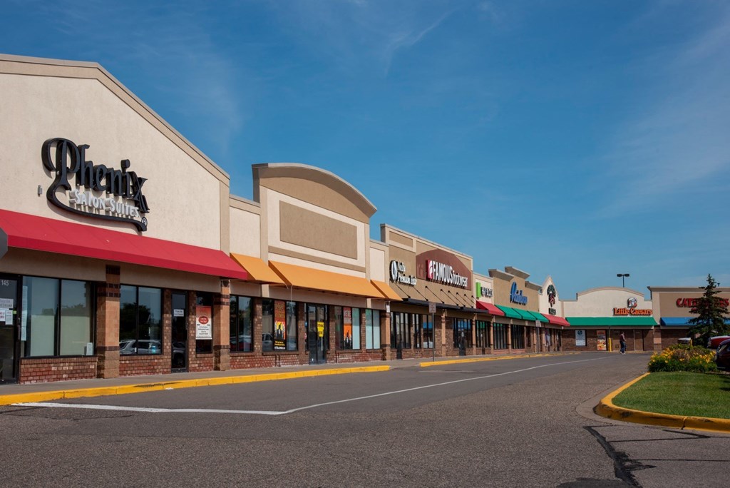 a row of stores on the side of a street