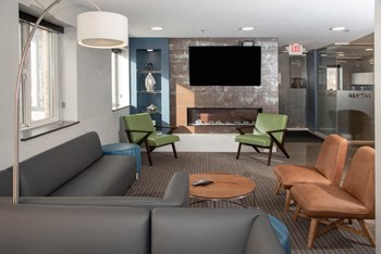 TV lounge in community space with fireplace - Photo Gallery 16