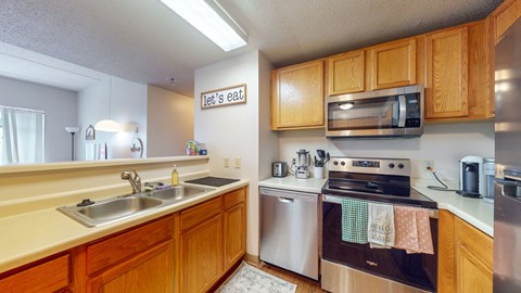 a kitchen with stainless steel appliances and wooden cabinets