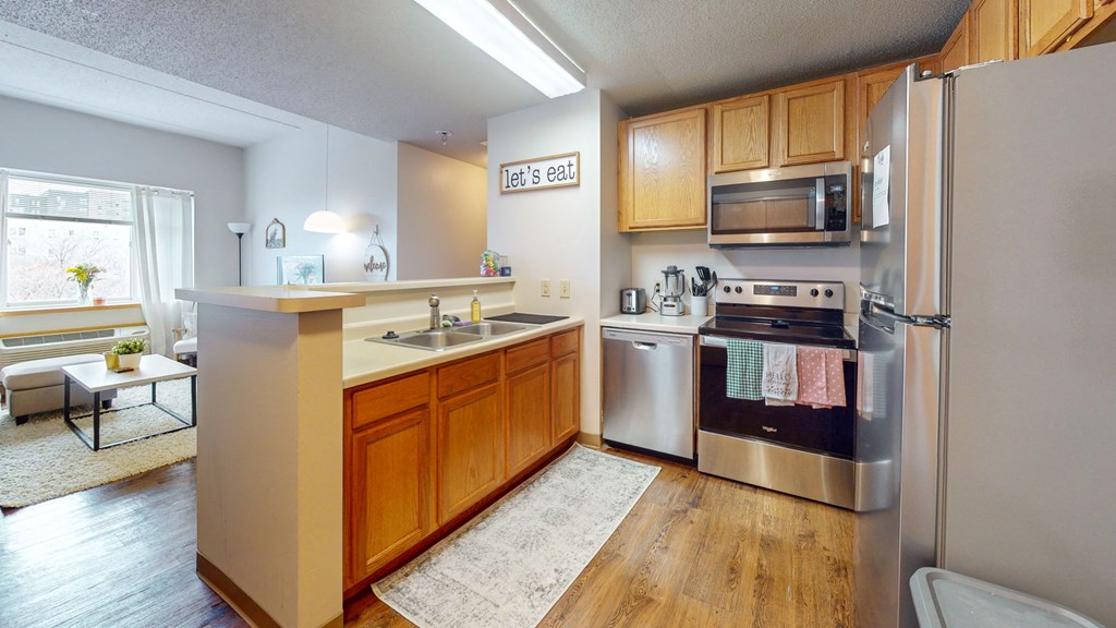 a kitchen with stainless steel appliances and wooden cabinets
