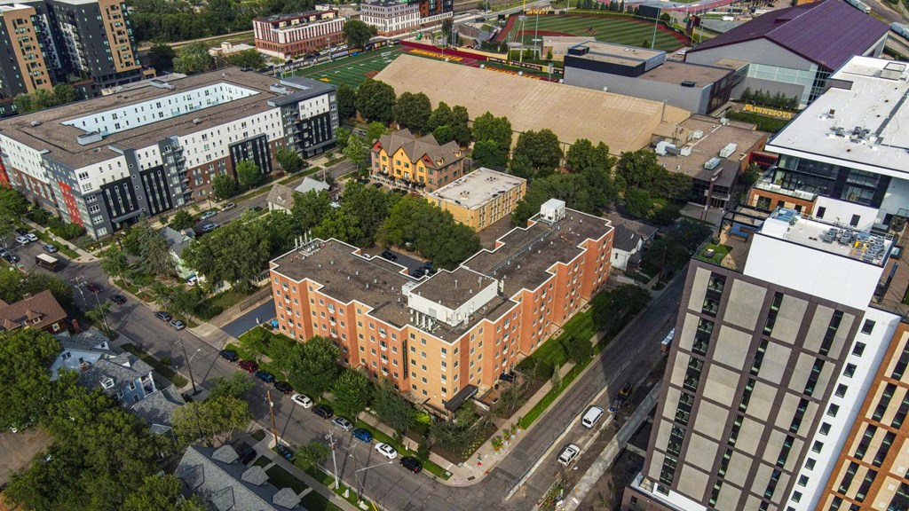 A large building is surrounded by other buildings. at Bierman Place, Minnesota