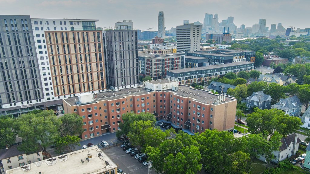 A cityscape with a large building in the foreground and a city skyline in the background. at Bierman Place, Minneapolis