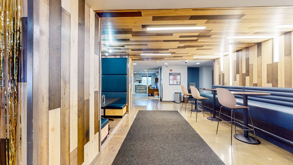 a lobby with tables and chairs and a blue couch