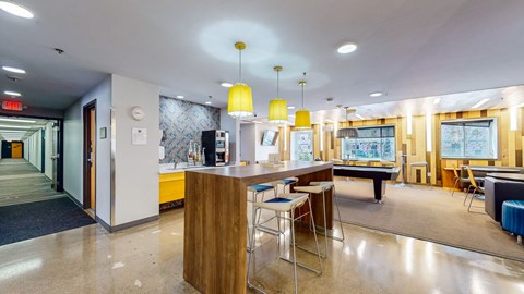 a clubhouse with a bar and a pool table