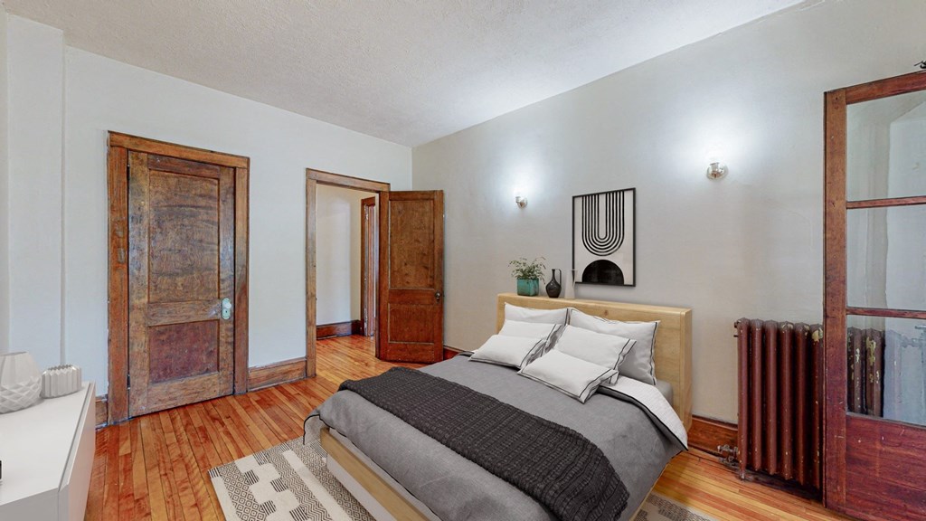 a bedroom with a bed and two doors