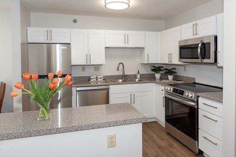 a kitchen with white cabinets and gray countertops  at Briarcliff Apartments, a 55+ Community, Mahtomedi