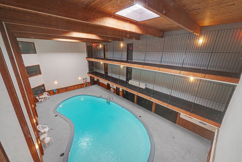 a view of the pool from the top of the building