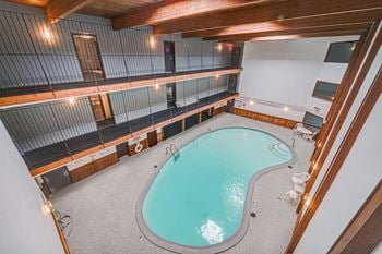 a view of the indoor pool and hot tub from the second floor of the building