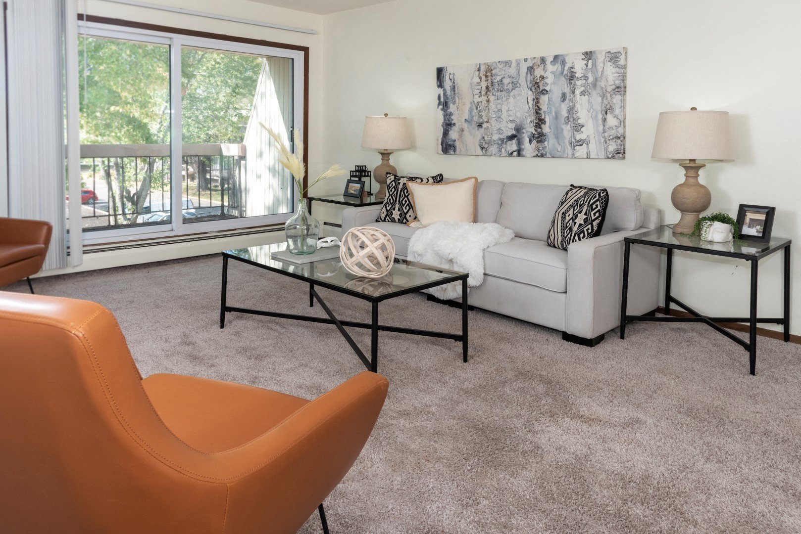 a living room with a couch and a table and a window