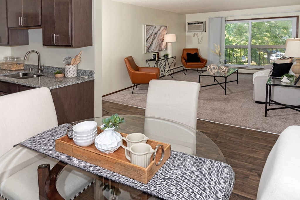 a living room and dining room with a glass table