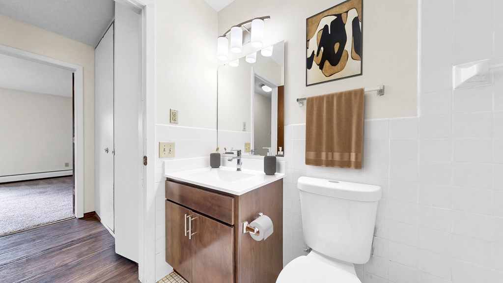 A white toilet sits next to a sink in a bathroom.