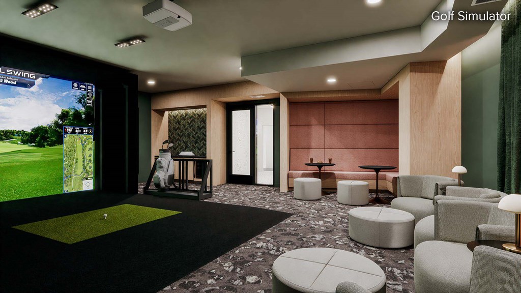 A room with a golf simulator and a green carpet.