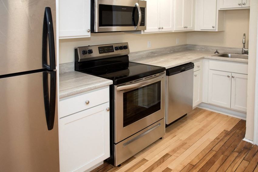 a kitchen with stainless steel appliances and white cabinets