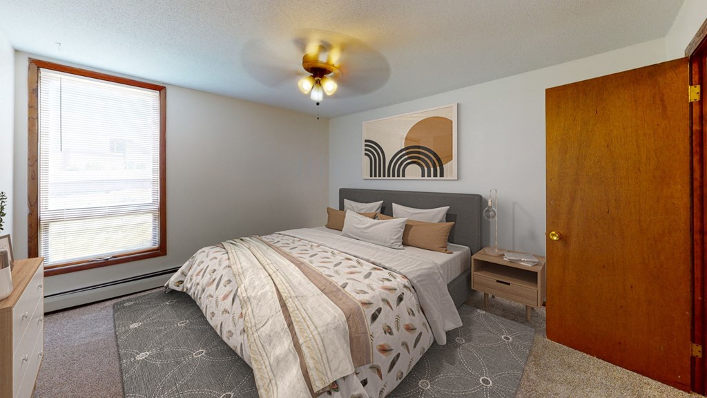 a bedroom with a large bed and a window