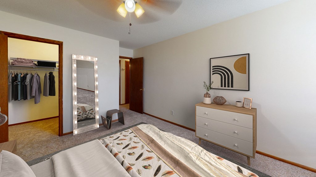 a bedroom with a bed and a closet with a mirror