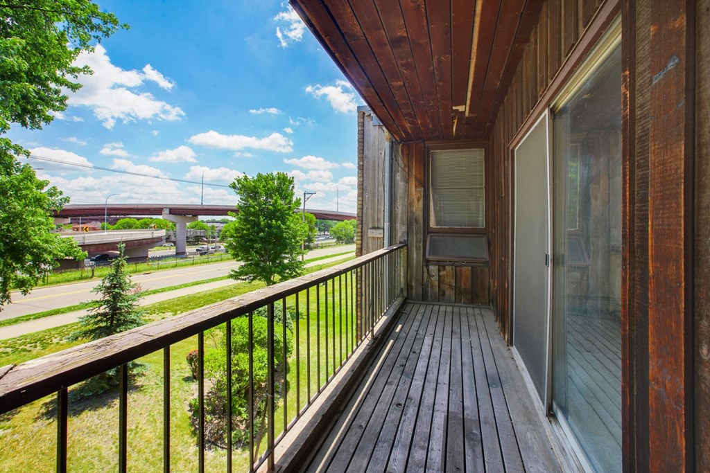 the view from the balcony of a home with a wooden deck